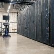 Rows of server racks inside a modern data center, used to illustrate AI infrastructure capacity