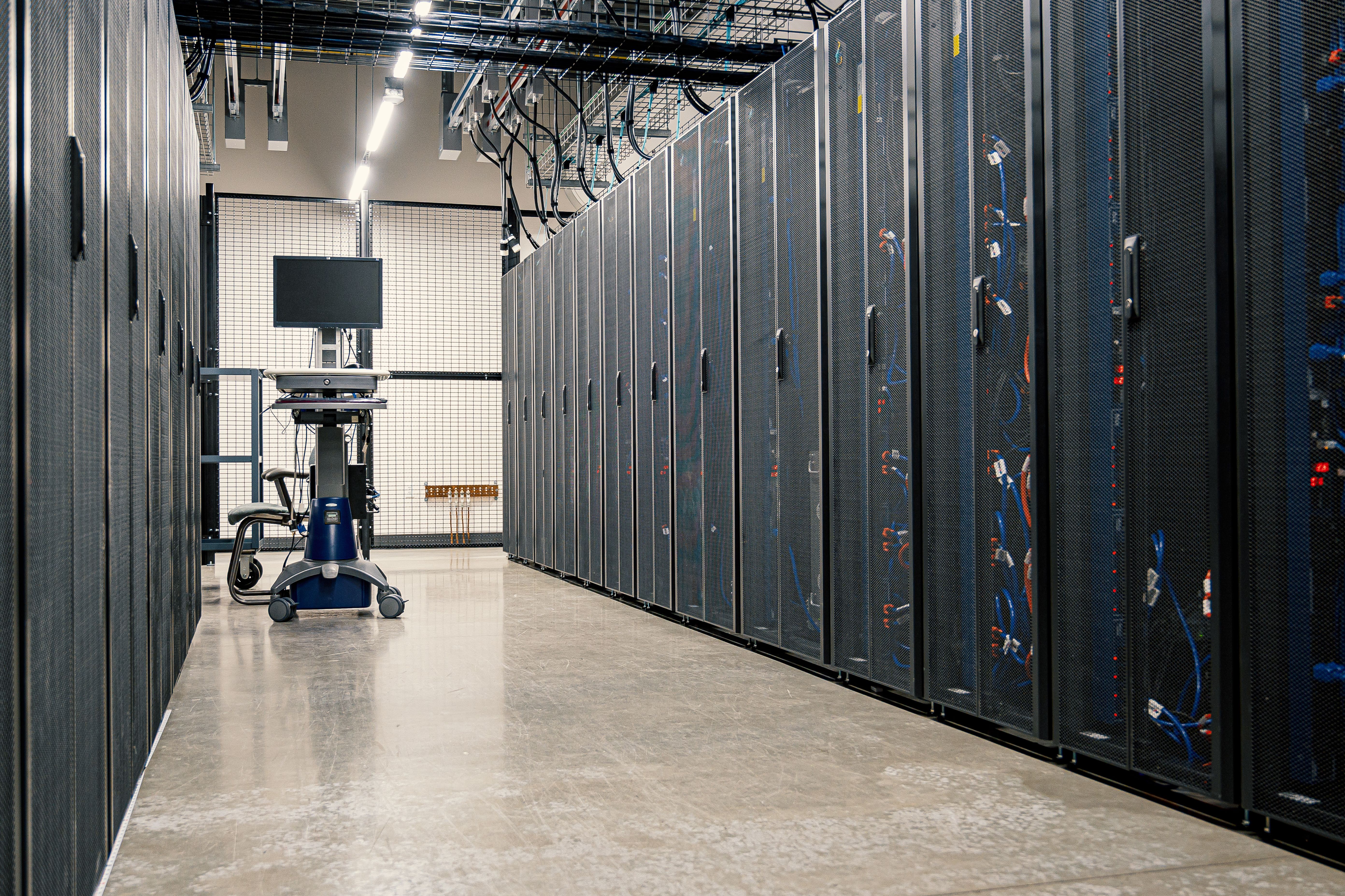 Rows of server racks inside a modern data center