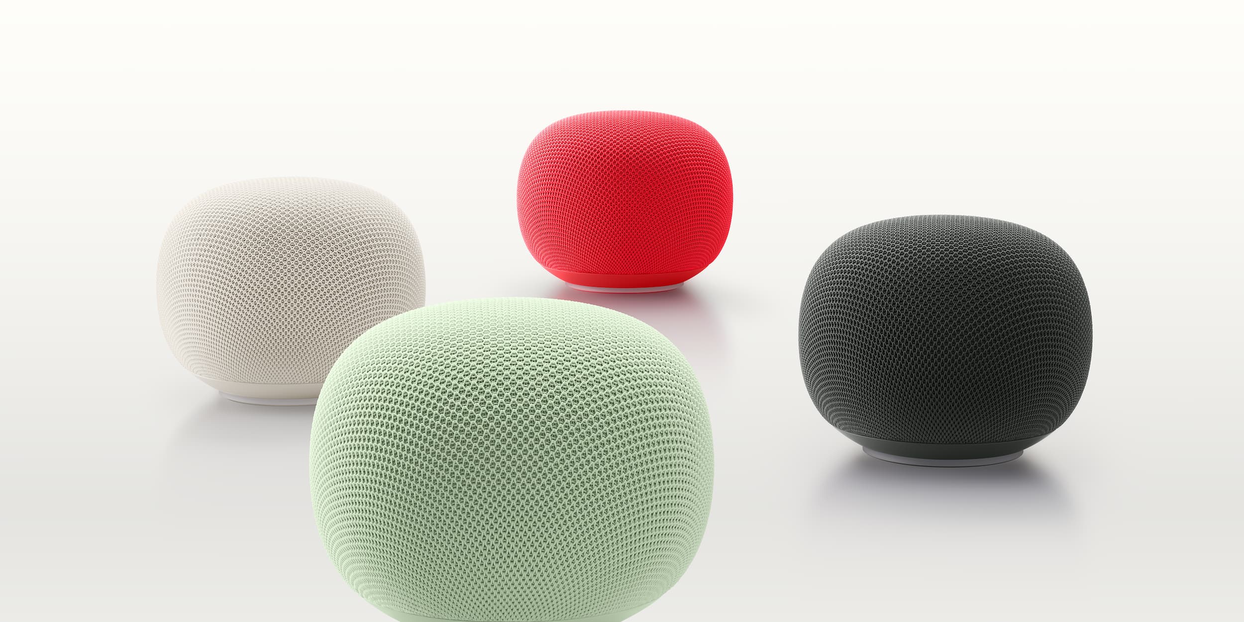 Google Home Speaker in Porcelain, Jade, Berry, and Hazel colors, representing Google's Gemini for Home smart speaker launch