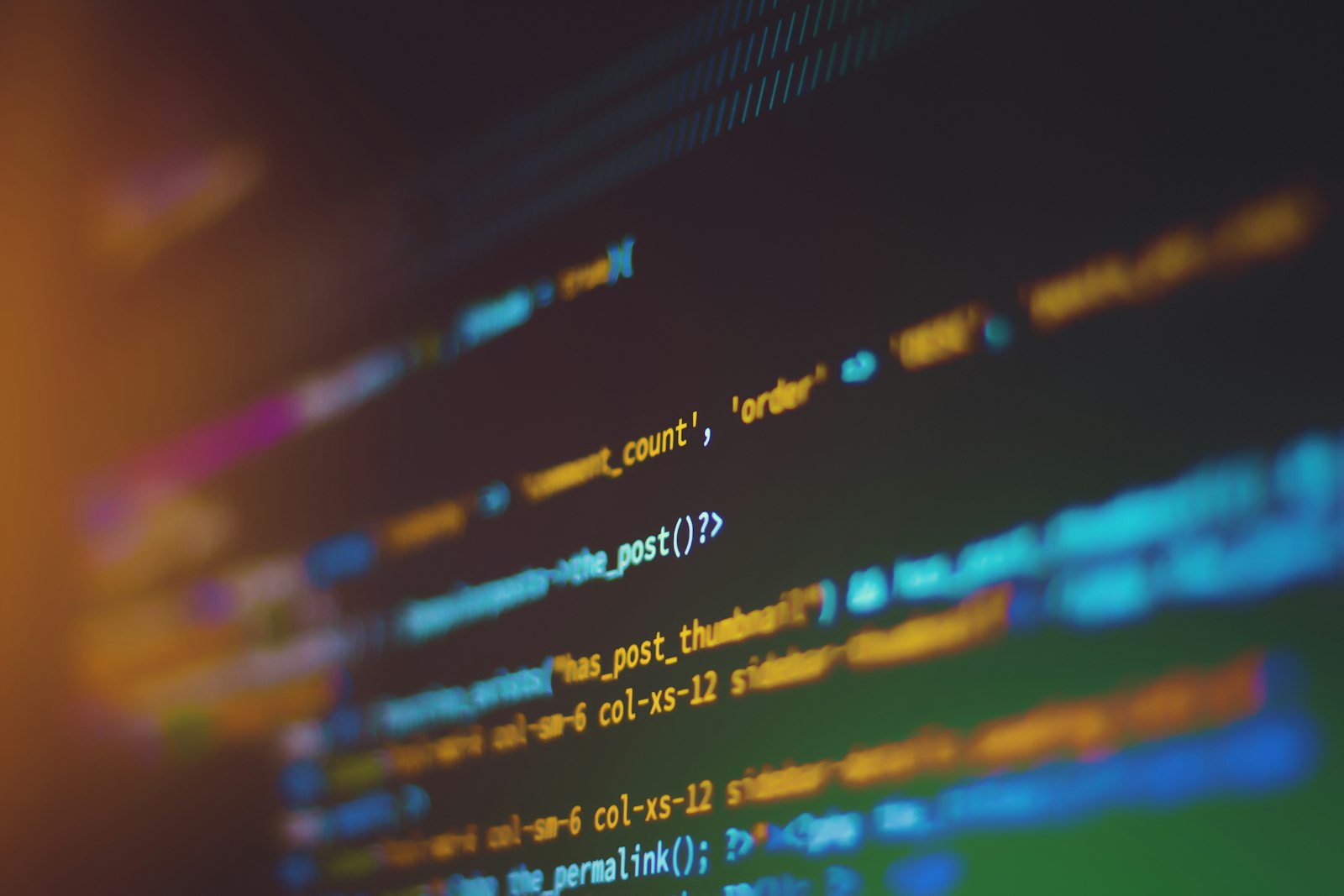 Close-up of colorful code on a developer screen, used to illustrate npm package security changes.