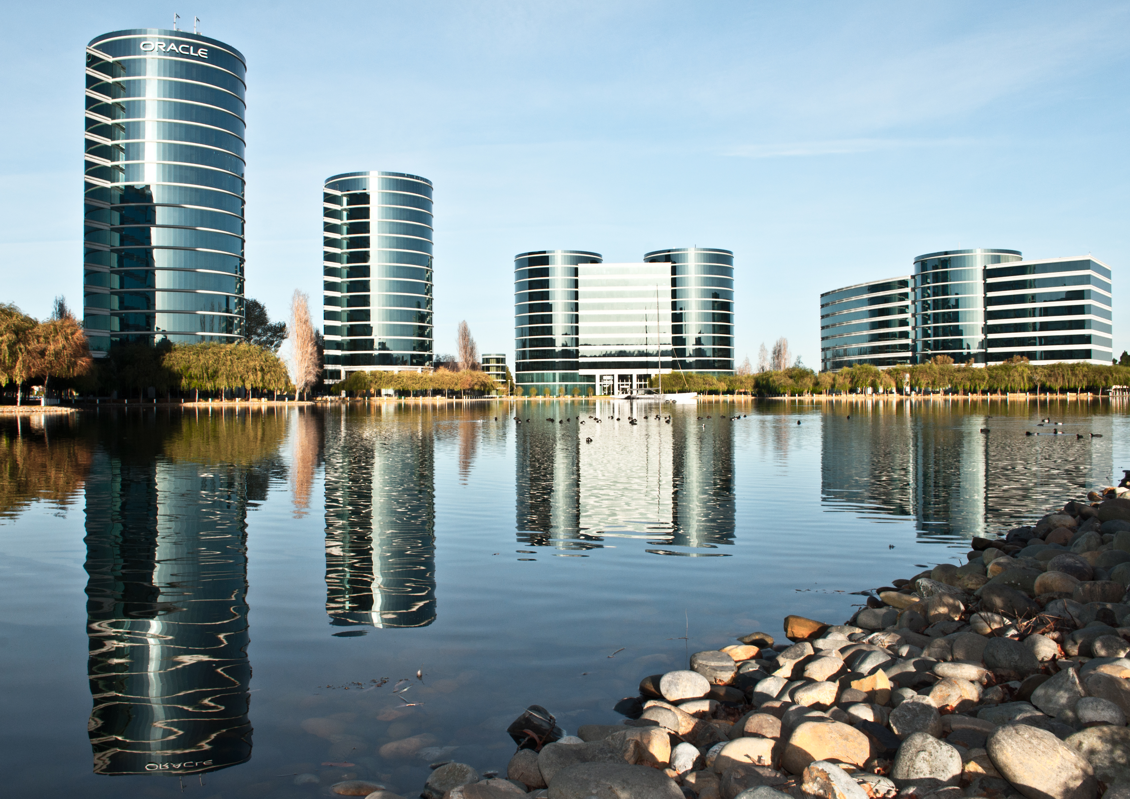 Oracle headquarters buildings in Redwood City reflected in water