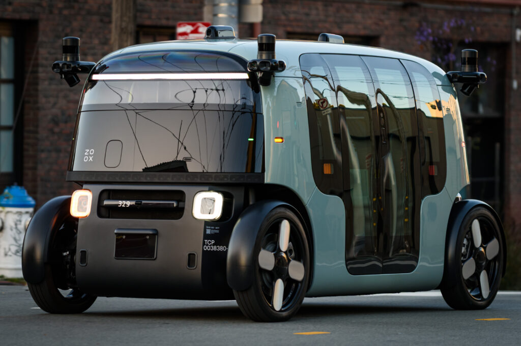 A Zoox autonomous robotaxi driving on a city street