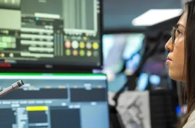 An operator monitors dashboards in a security operations center