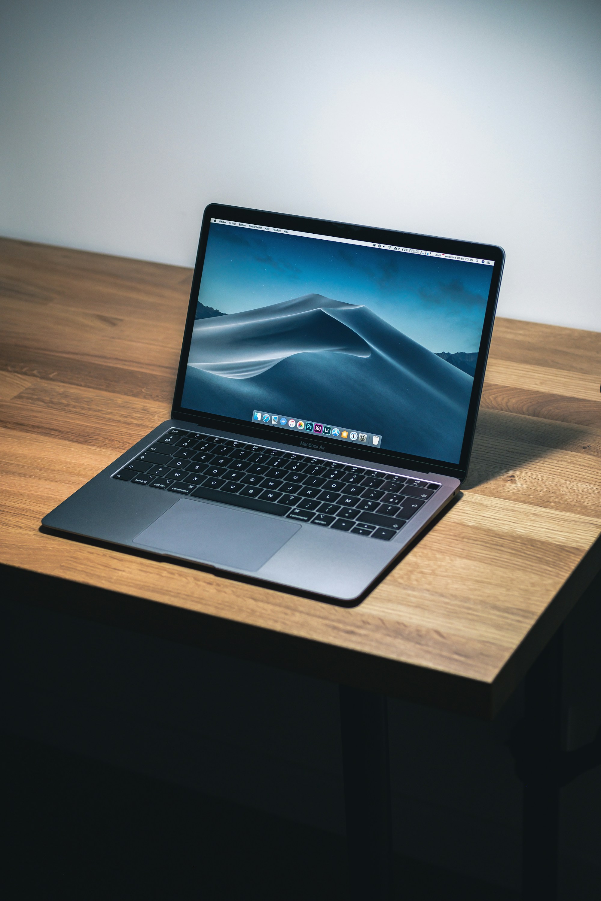 MacBook Pro open on a wooden desk